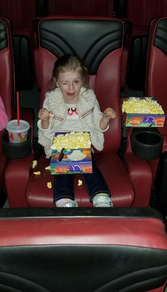I took my 3 year old to her first movie and caught her with the flash on!