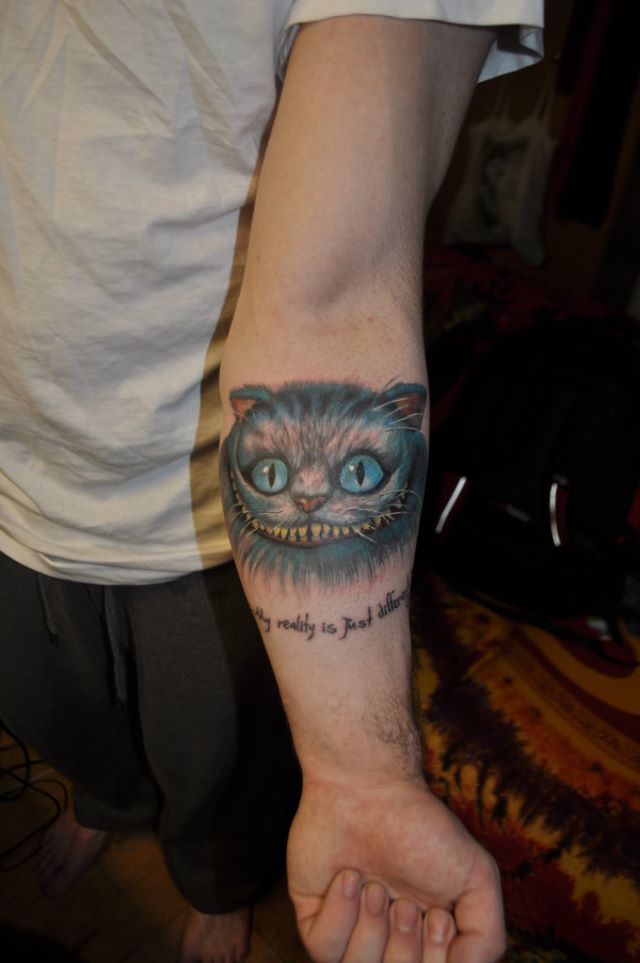 My first tattoo, the Cheshire Cat. Quote reads, “I’m not crazy. My