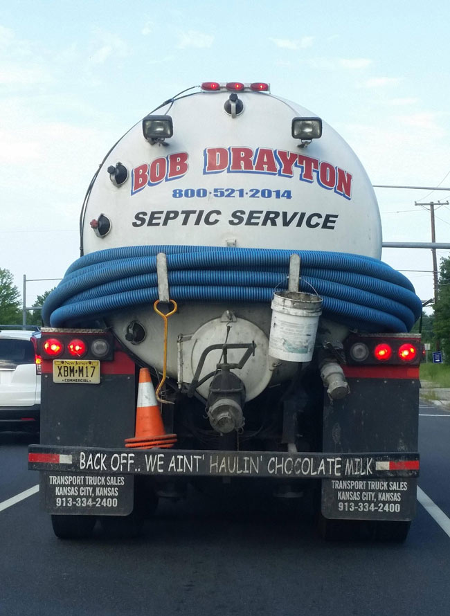 Tailgate warning on a truck hauling septic waste.