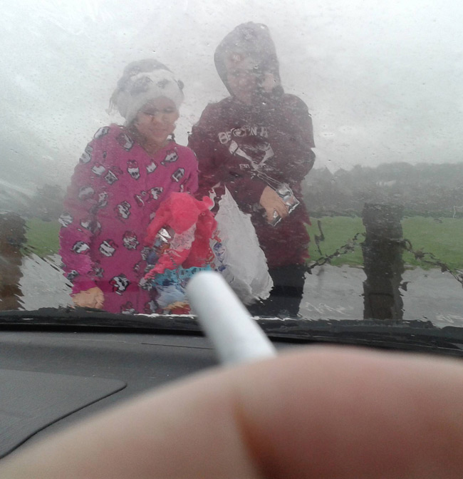 I don't think the kids like this "no smoking in cars with children" law all that much when the weather is this bad!