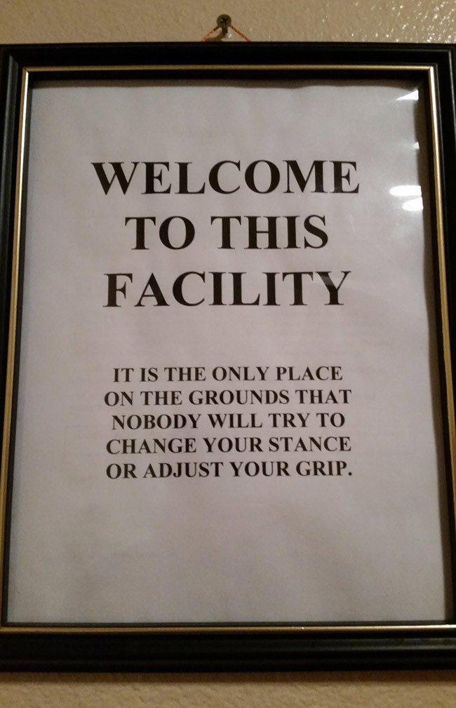 Sign inside of local tennis club bathroom