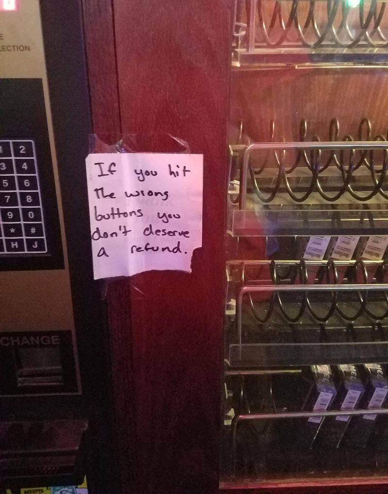 Sign on a cigarette machine in a local bar
