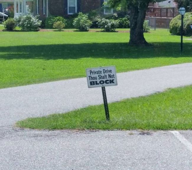 Guy's driveway merges with a church parking lot, love the sign