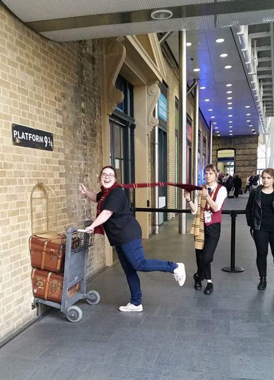 The girl working platform 9 3/4 is really tired of adult children posing for pictures