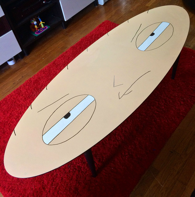 Had an old oval shaped coffee table with a messed up top so I painted it into something I thought the shape was perfect for