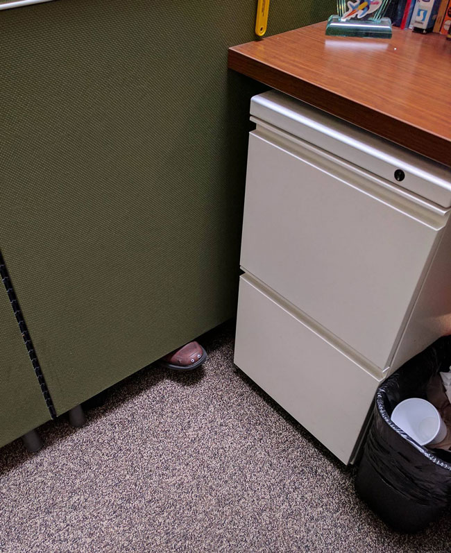 My coworker keeps on placing his foot under our divider, so I added some googly eyes