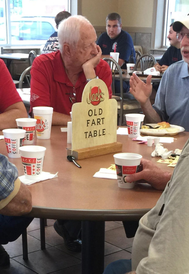 These guys sit at this table every morning. The restaurant owners made this sign to reserve it for them