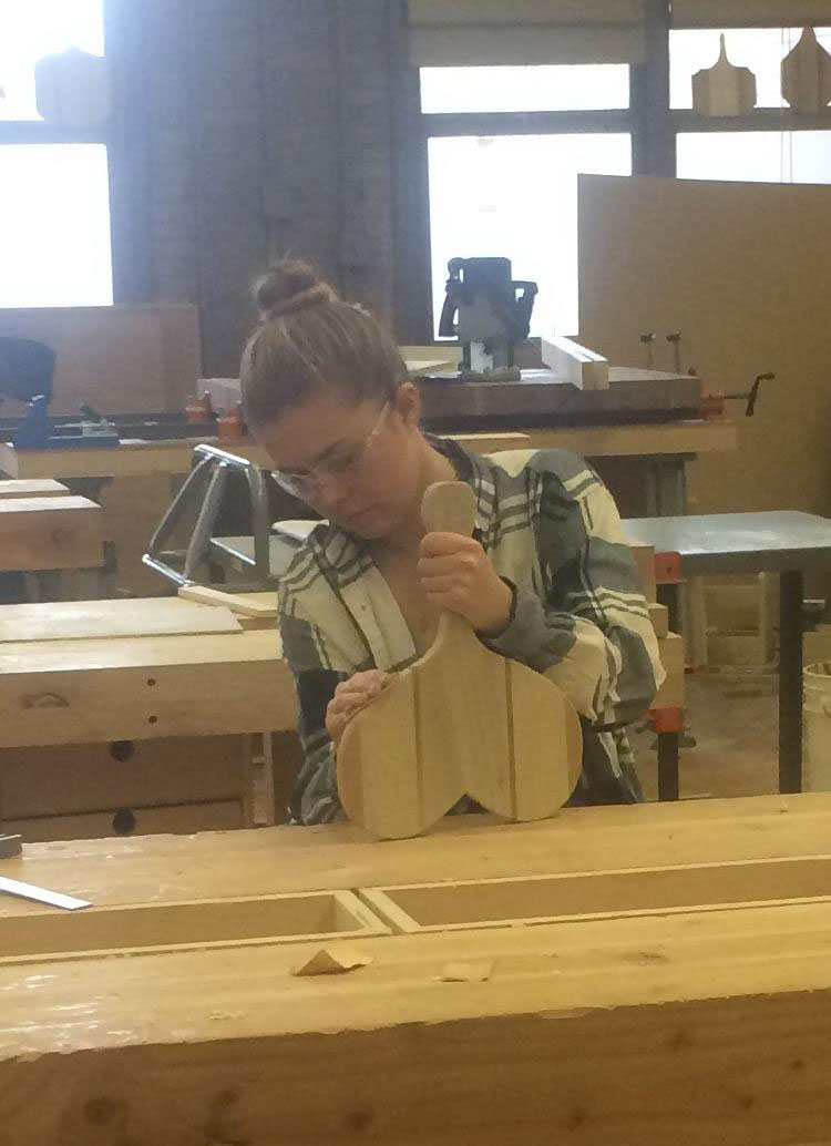 This girl's heart-shaped cutting board