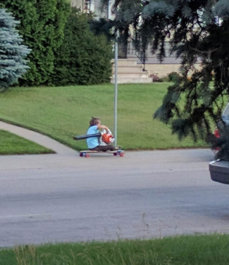 This kid on a longboard using a leaf blower for power is now my personal hero