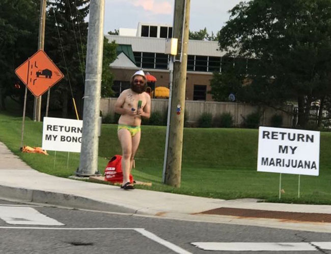 Saw this guy biking downtown a week ago in a Speedo, smoking a bong. This is him protesting outside the police department