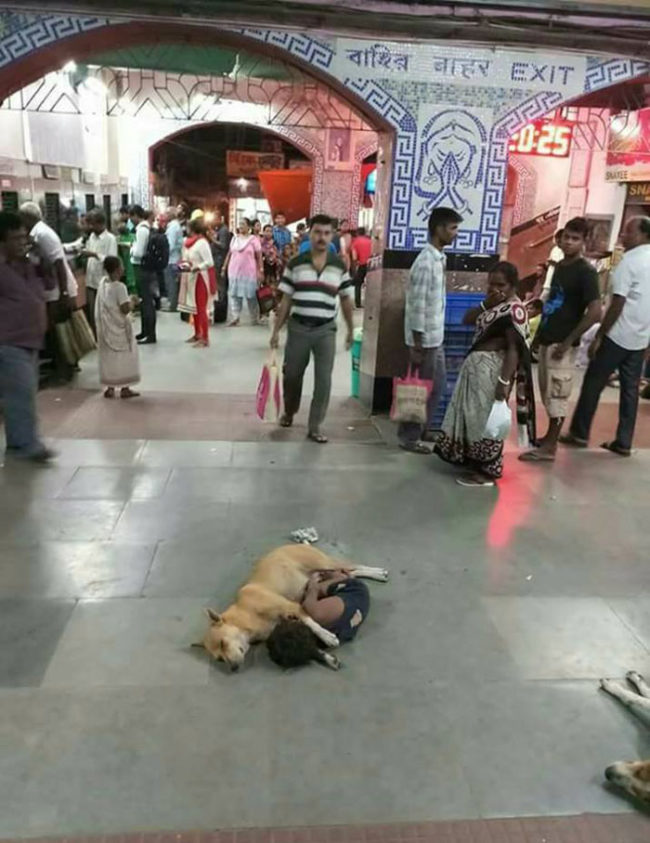 Homeless kid in a crowded Indian railway station