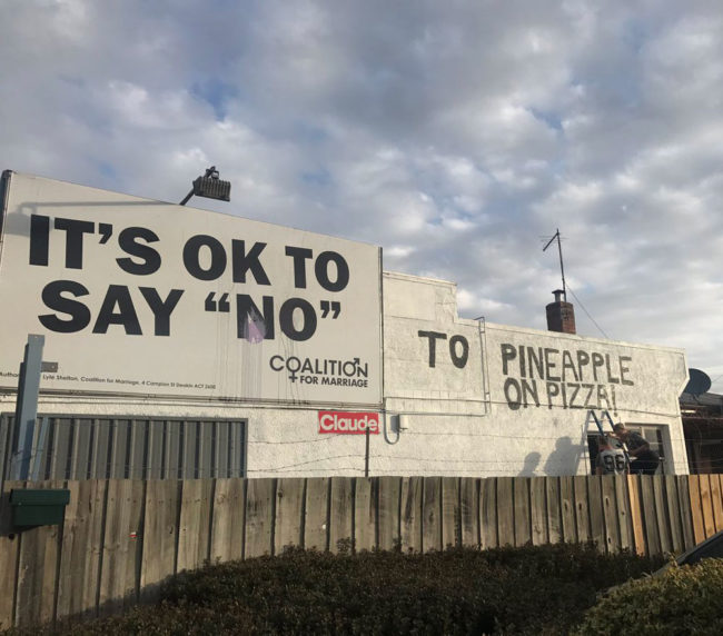 The owners of a pizza shop in Launceston, Tasmania, have painted around an anti-same sex marriage billboard on their building
