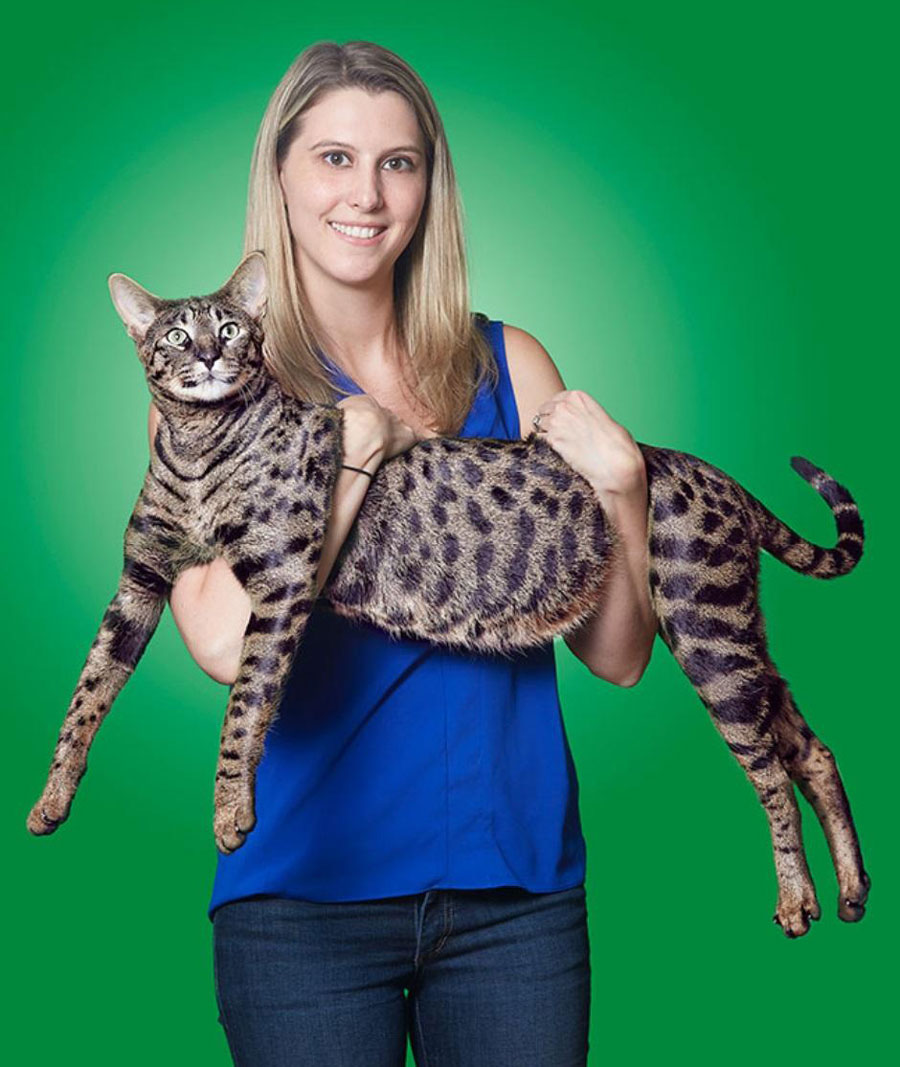 My wife holding our cat Arcturus, who now holds the title for the tallest domestic cat ever!
