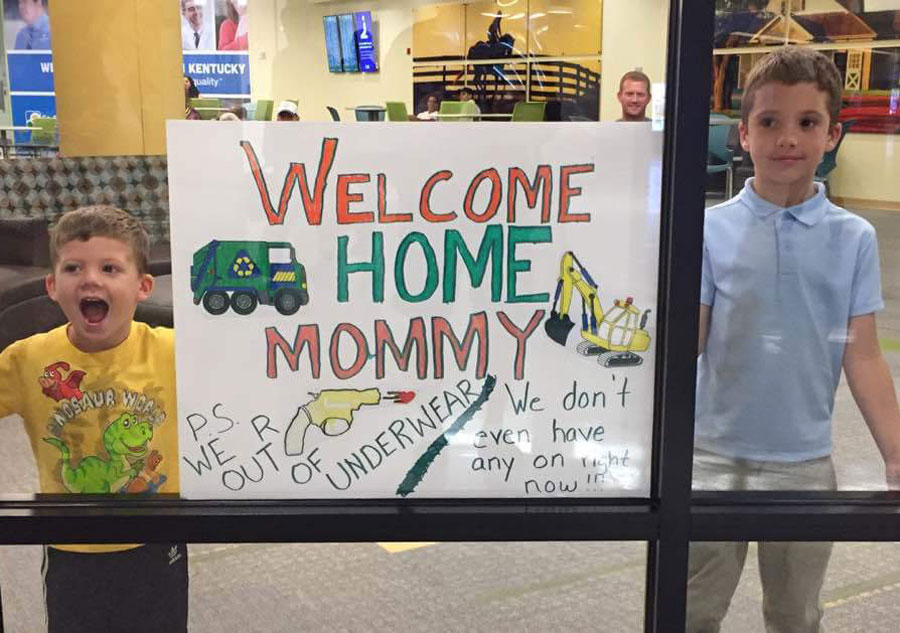These kids at the airport welcoming their mother back home