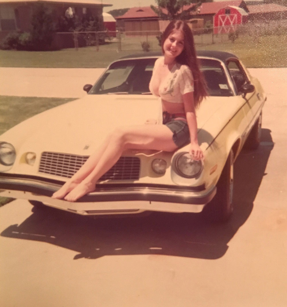 My mom at 16 yrs old with her Camaro in 1975