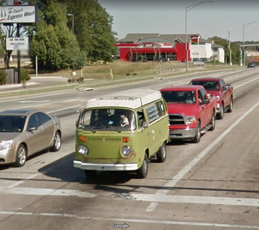 Pug driving a VW bus in google streetview (I barely had enough time to hoist him up there)
