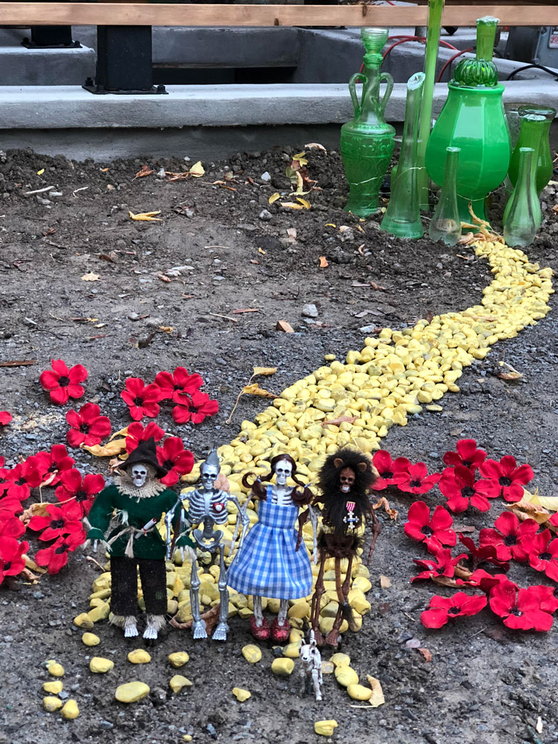 Tiny and creepy yellow brick road on neighbor's front lawn