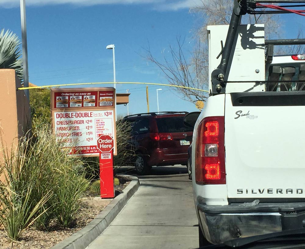 Bored in line at In-N-Out, these construction workers tried to see what they could reach with their measuring tape