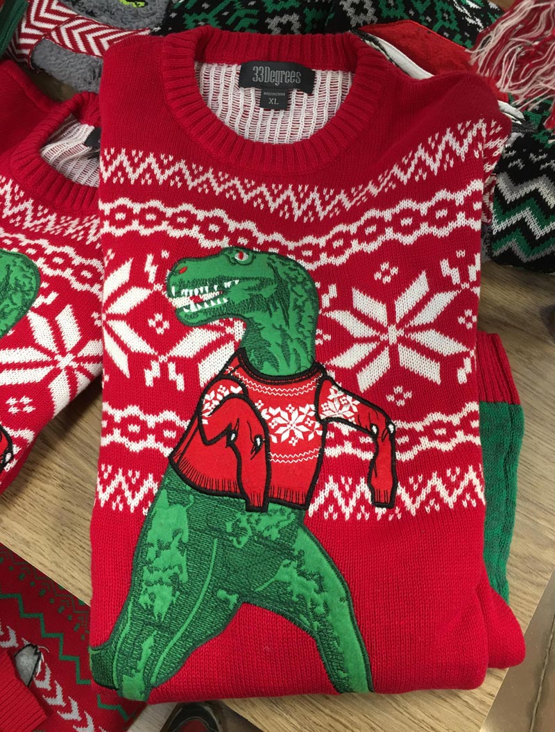 The dangling sleeves on this T-Rex Christmas sweater