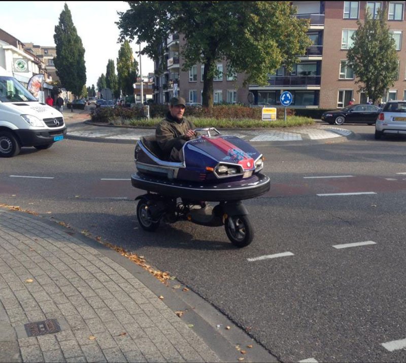 A man from my city mounted a carnival bumper car to his scooter