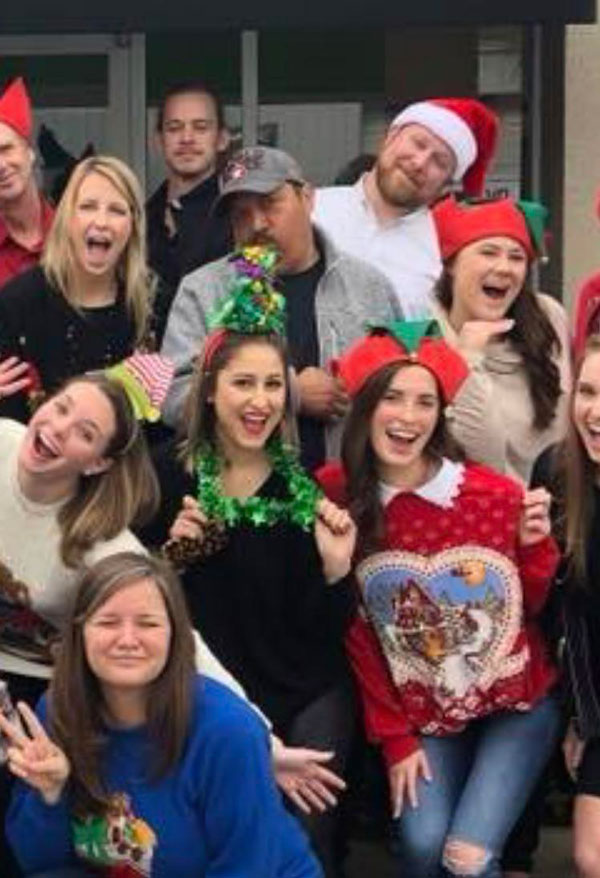 My coworker looks like he is spewing Christmas joy all over the girl in front of him