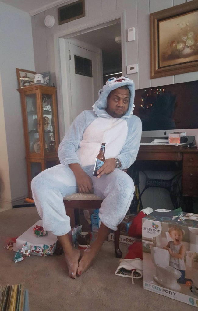 My brother-in-law, who has 2 girls, taking in the aftermath of Christmas morning, wearing a Yeti Onesie, that they picked out for him