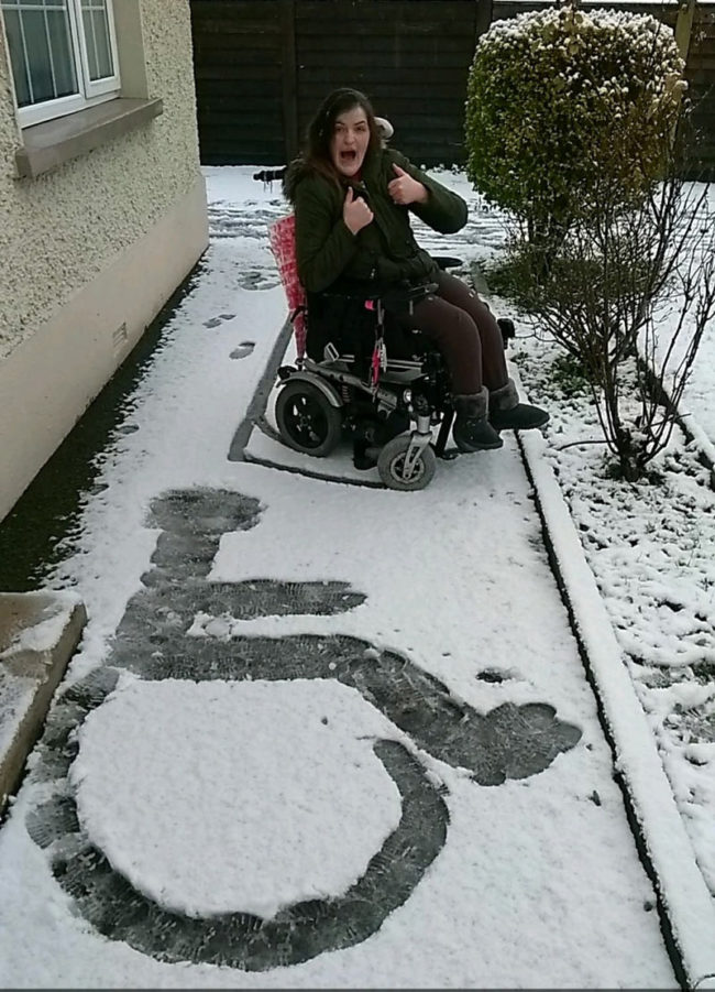 My sister proudly showing off her first snow angel!