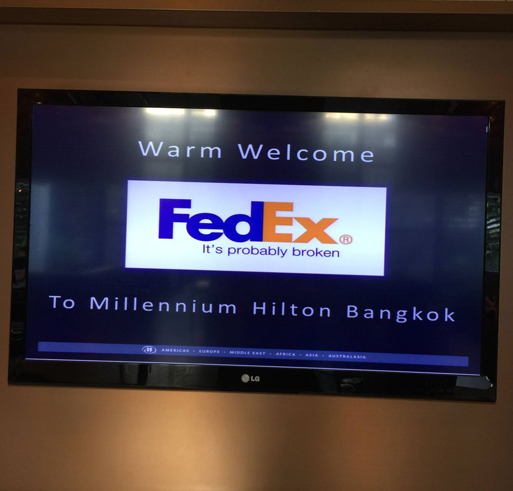 "We need to show we're sponsored by FedEx." "No prob. I'll grab something off the Internet." Seen at the Millennium Hilton, Bangkok