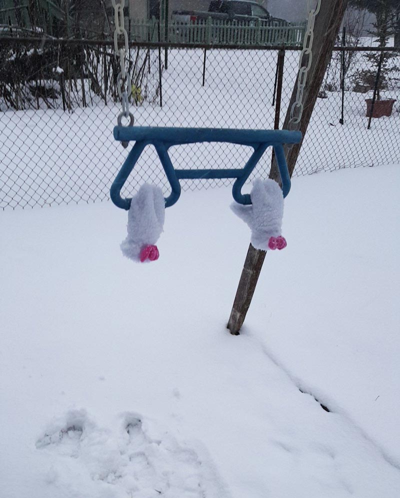 My daughter wanted to go swing in the snow. She fell right out of her gloves