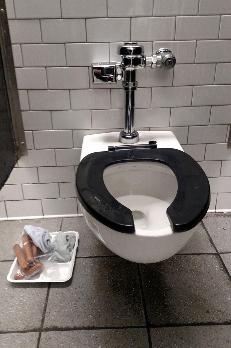 I’ve seen some strange things in my day, but a lunch tray, bag of hot dogs and dirty socks in a bathroom stall?