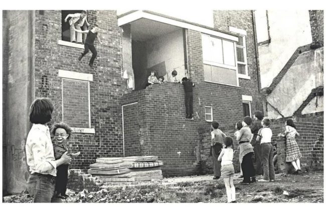 Kids jump from a window onto mattresses in Newcastle, 1979