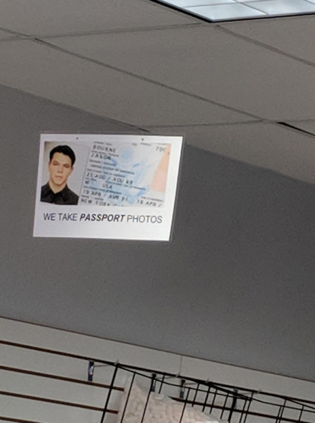 This mail store has Jason Bourne's passport as an ad for passport photos