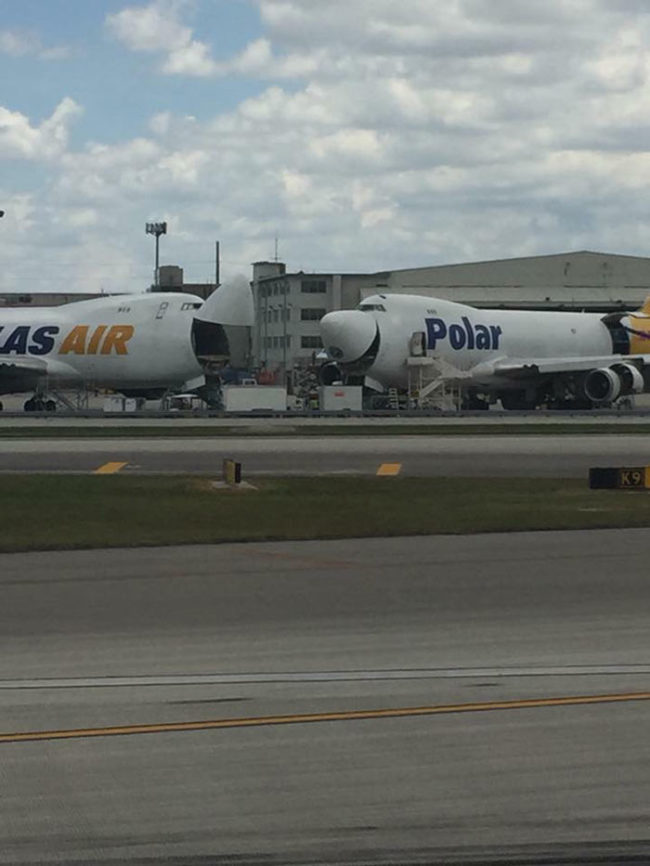 Two jumbo jets cracking a joke and having a good laugh at Miami International Airport
