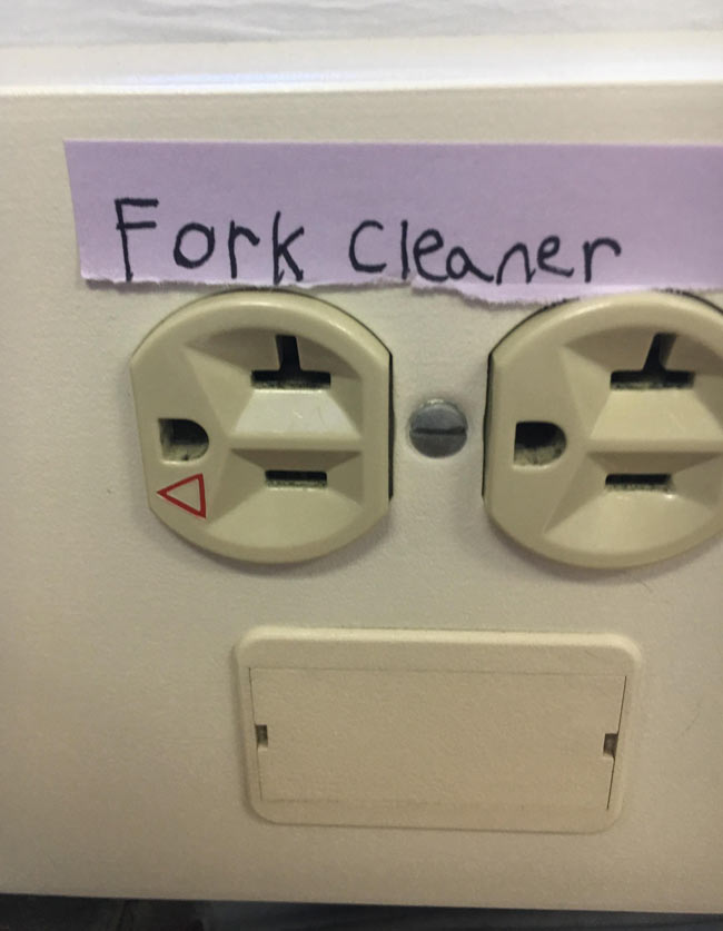 Someone put a helpful label on the electrical outlet at school