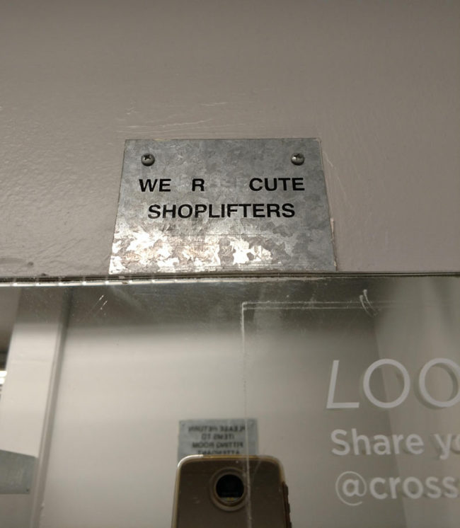 vandalized sign in a Crossroads fitting room