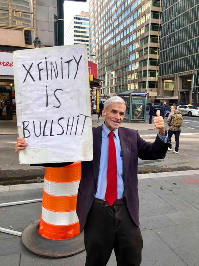 A one person protest in front of Comcast HQ in Philly