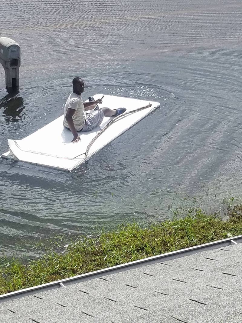 My neighbor using his gate as a raft, after hurricane Irma hit. He ...