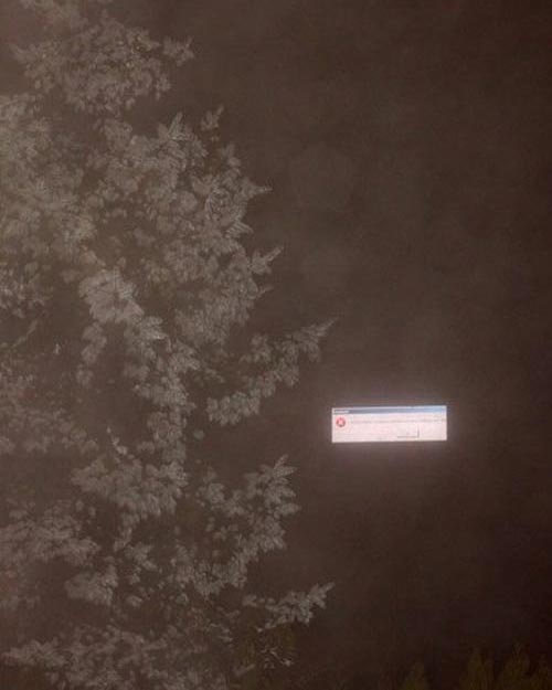 Digital billboard crashed on a foggy night, so it looked like there was a giant error warning floating around in the sky