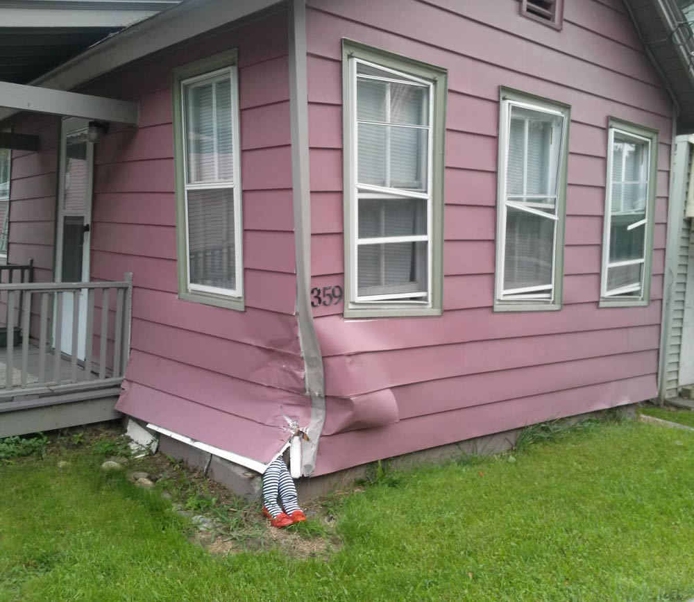 After a car hit this house, somebody added witch's legs.