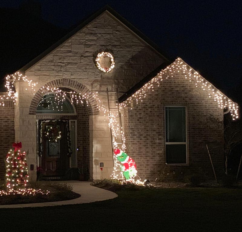 My friend wasn’t able to reach the higher roofline, so he decided the Grinch would steal the lights