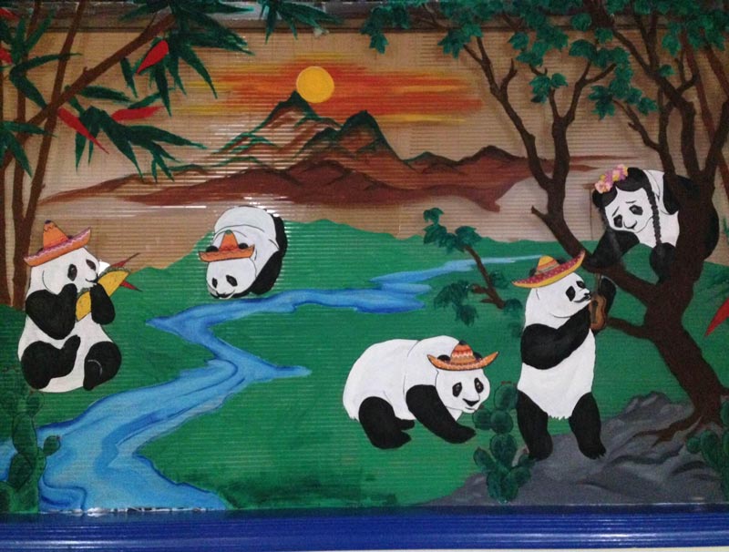 This Mexican restaurant used to be a Chinese restaurant so instead of painting over the pandas they just put sombreros on them