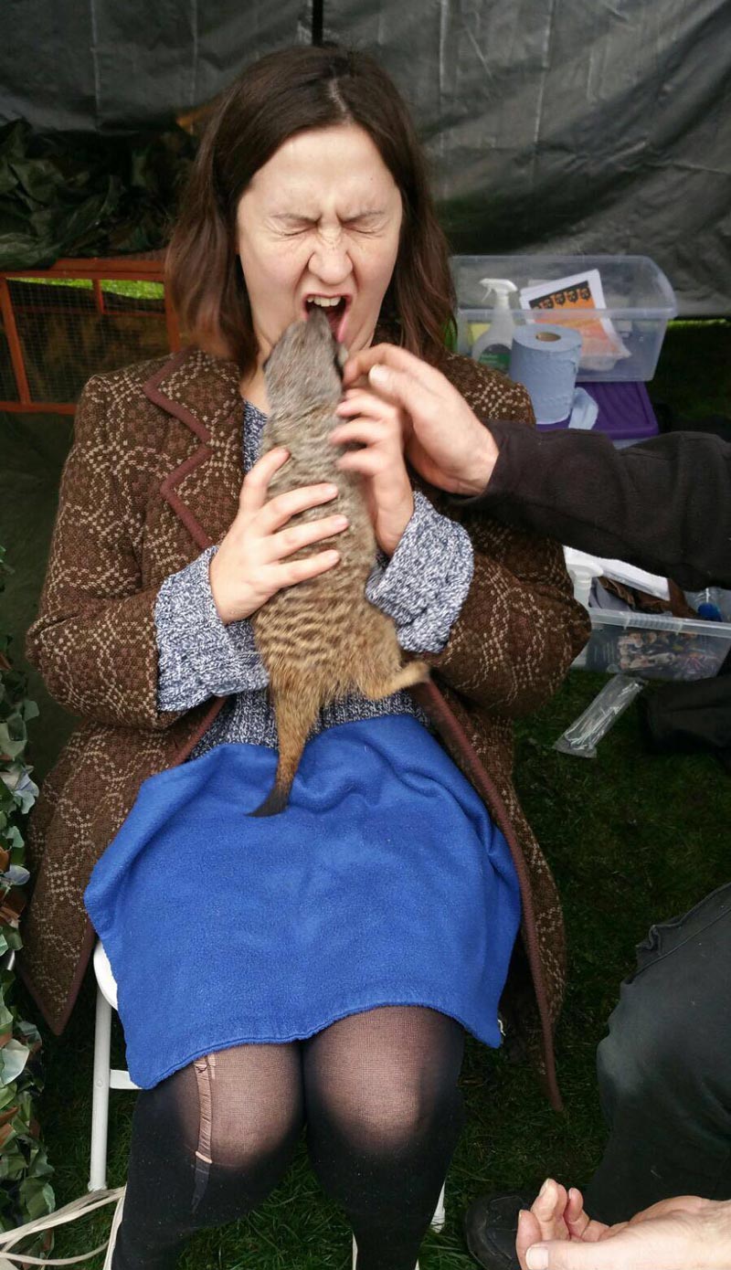 My sister holding a meerkat