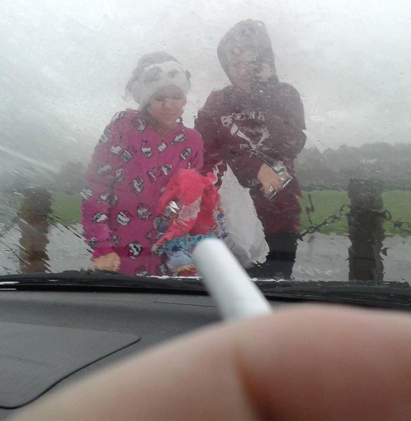 No smoking with kids in the car law is ridiculous. Just look at them out there in the rain