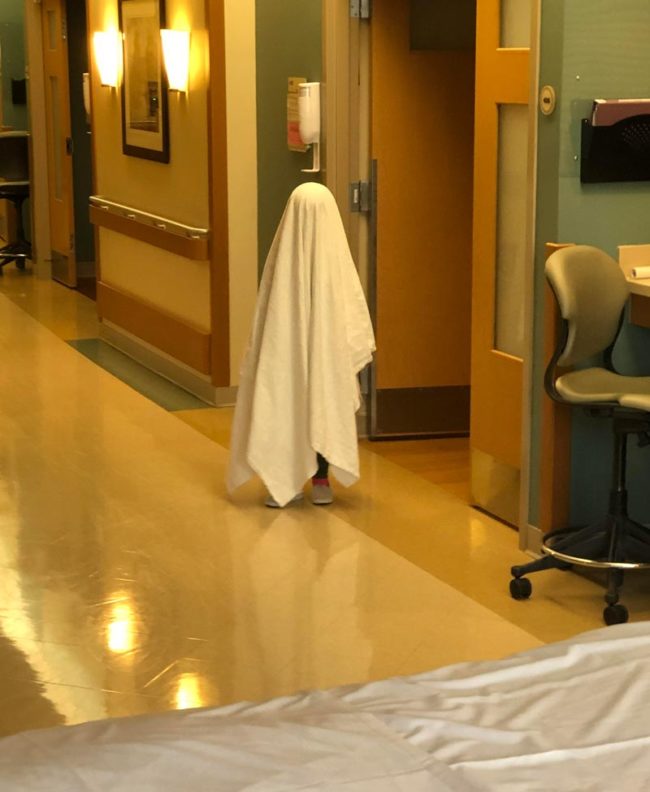 My daughter pretending to be a ghost at the hospital. Probably a poor choice
