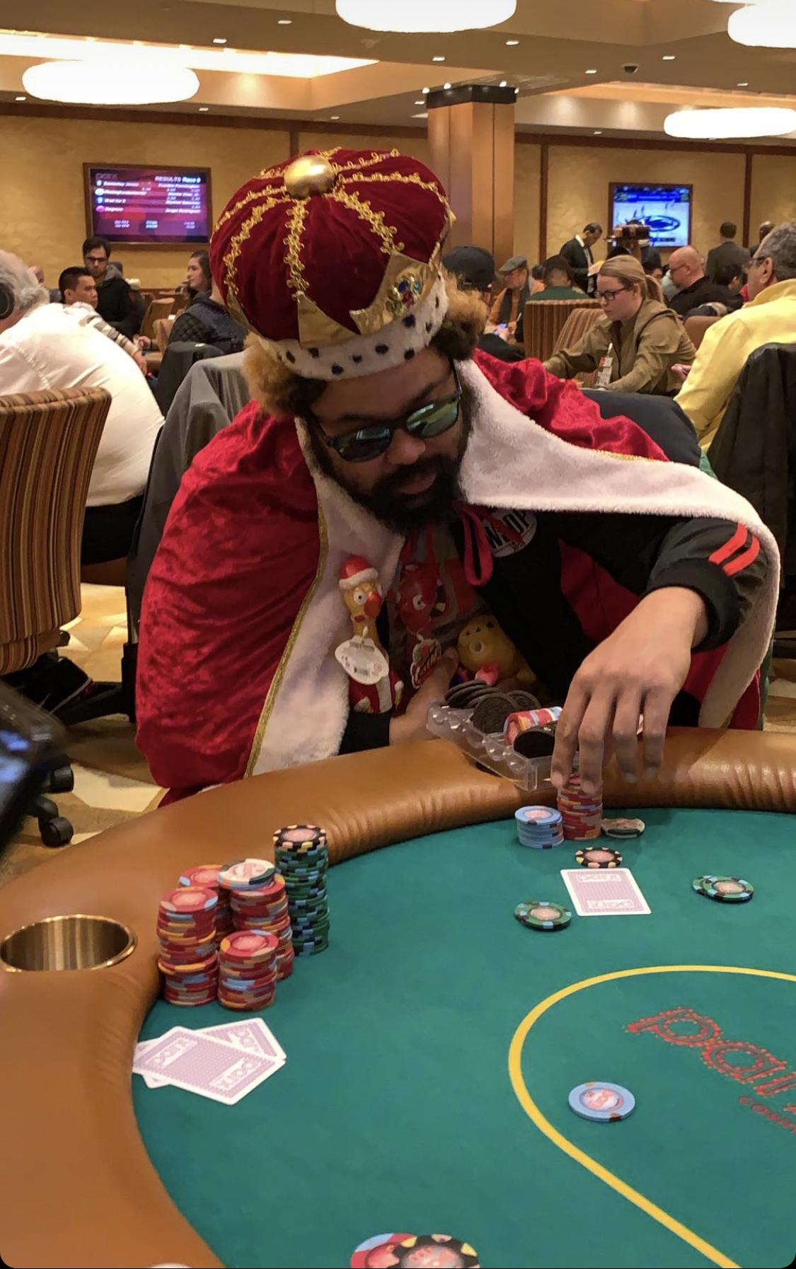 This guy dressed as the Burger King at a poker table with Oreos in his chip holder