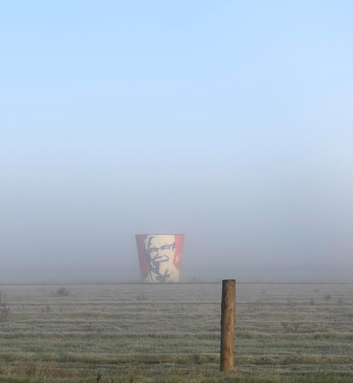 Local KFC got pulled down a few years back, owner kept the old bucket and put it on his property near the highway. It was foggy a few days ago and was able to capture this