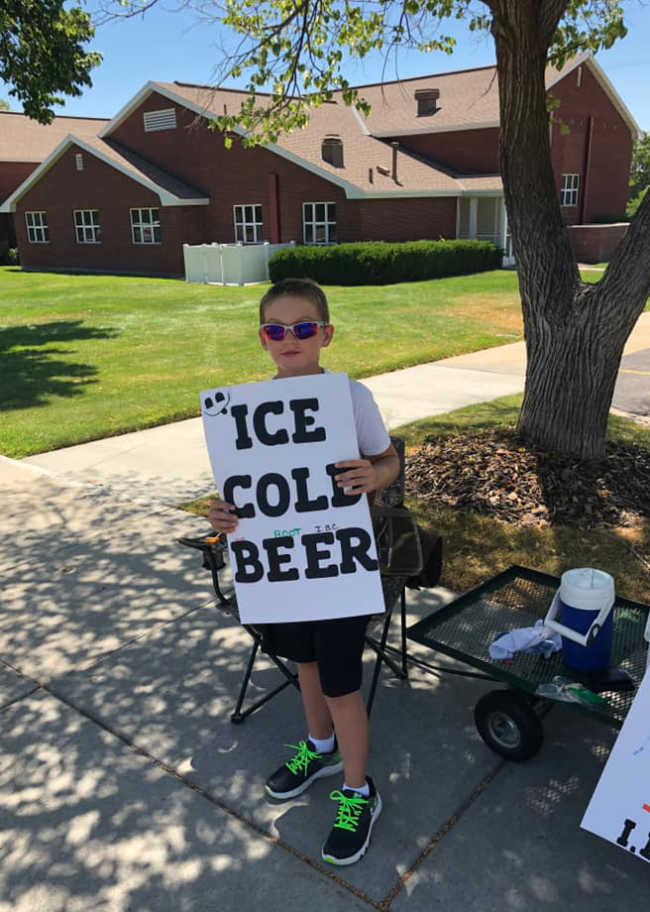 Utahns called the cops on this kid selling "ICE COLD root BEER" outside a LDS Church