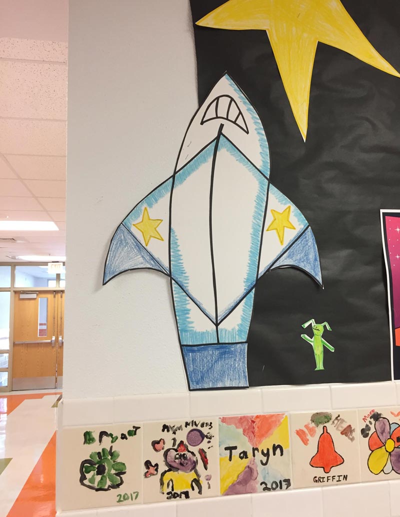 I was at my daughter's school today. I asked her why there was a shark ripping off its shirt.. Her reply: "mom, that's a rocket ship"