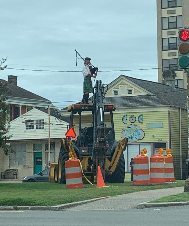Not everyday you see a bagpiper on construction equipment, stay odd New Orleans