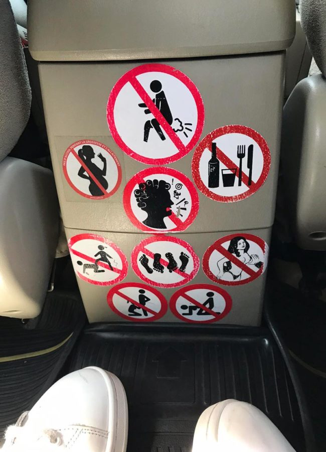 Stickers in the back of a taxi on my vacation in Thailand